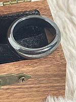 Band ring resting on small wooden box showing overall appearance