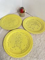 All three yellow ceramic plates displayed