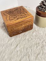 Closed carved oak jewellery box angled view