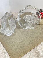 Full view of both glass bookends showing wolf and elephant designs