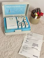 Open travel kit showing converter, adapters and instruction leaflet