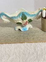 Full view of porcelain lusterware candy dish showing overall shape, handles and pedestal