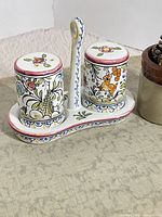 Full view of salt and pepper shakers on handled holder