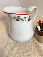 Full side view of porcelain pitcher showing motif and form