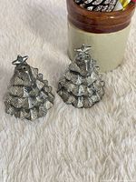 Front view of both shakers showing Christmas tree shape and silver finish