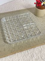 Full view of square divided glass dish showing star and cross cut pattern