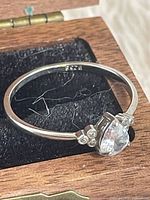 Top view of sterling ring showing pear-cut stone and bead accents