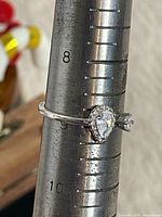 Full view of sterling silver ring on mandrel showing pear stone and size