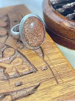 Ring on wood surface showing gemstone sparkle