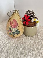 Front view showing ornament with rose motif beside staging props