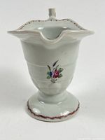 Front view showing floral motif and scalloped rim