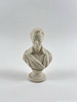 Front view of Parian bust on pedestal, repair lines visible