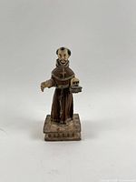 Front view of entire santo figure on plinth