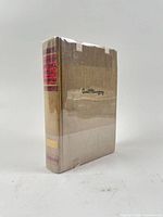 Spine and front board showing cloth, spine labels, clear wrap