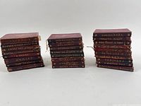 All 26 red leather Temple Shakespeare volumes in three stacks