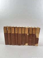 Ten volumes standing side by side showing overall condition of dust jackets
