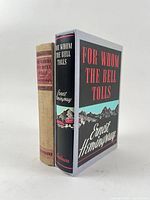 Two Hemingway hardcovers side by side: tan cloth and jacketed copy in slipcase