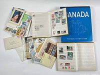 Overall lot showing three albums, loose stamps and blue Canada album