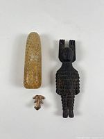 Group shot showing wooden figure, stone corn carving, gold-tone frog pendant