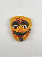 Full front view of painted plaster mask