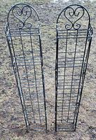 Two matching tall metal wire spice racks side by side