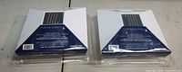 Two sealed Deckorators solar cap lights front packaging