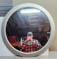 Front view of round mirror showing silver frame and reflective surface