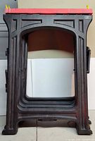 Front view showing stackable black plastic saw horse with red top and yellow supports