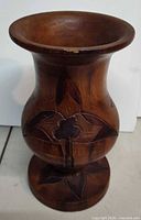 Full view of carved wooden vase front