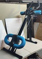 Full view of Merach ab trainer standing upright