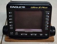 Front view of Eagle Ultra II Plus fishfinder head unit on wood block