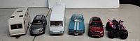 Front view lineup of six toy vehicles