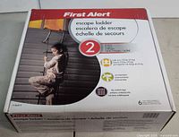 Front of sealed box showing First Alert branding, product length, capacity and features