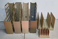 Front view of all seven beige plastic office organizers