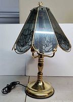 Full view of brass lamp with glass shade
