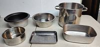 All six stainless steel kitchen items on table