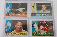 Fronts of four 1960 Topps baseball cards in sleeves