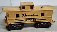 Side view showing Pacemaker NYC graphics and metal trucks