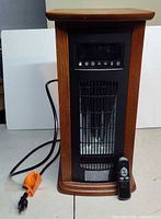 Heater angled front view with power cord and remote visible
