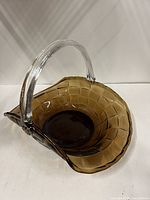 Oblique view showing amber bowl and clear handle