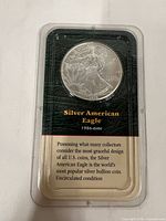 Obverse of silver American Eagle in Littleton holder with front label