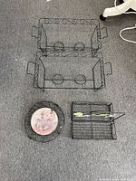 Two identical black metal chafing dish racks with scroll sides and fuel can holders, plus trivet and caddy overview