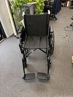 Front view of black Equate wheelchair with footrests attached
