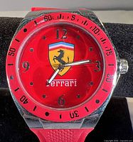 Front view showing red dial, Ferrari logo and bezel markings