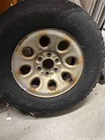 Full view of tire mounted on multi-hole steel rim