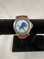 Front view of wristwatch on display stand showing dial and logo