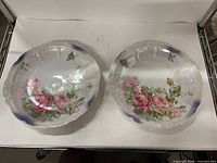 Two matching porcelain plates with rose pattern