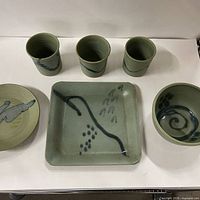 All six Hilborn Pottery pieces displayed: three tumblers, square plate, round plate, round bowl