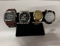 All four watches on display stand