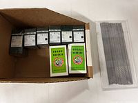 Open carton showing Groz-Beckert boxes, Organ Needles boxes and plastic sleeve of long needles